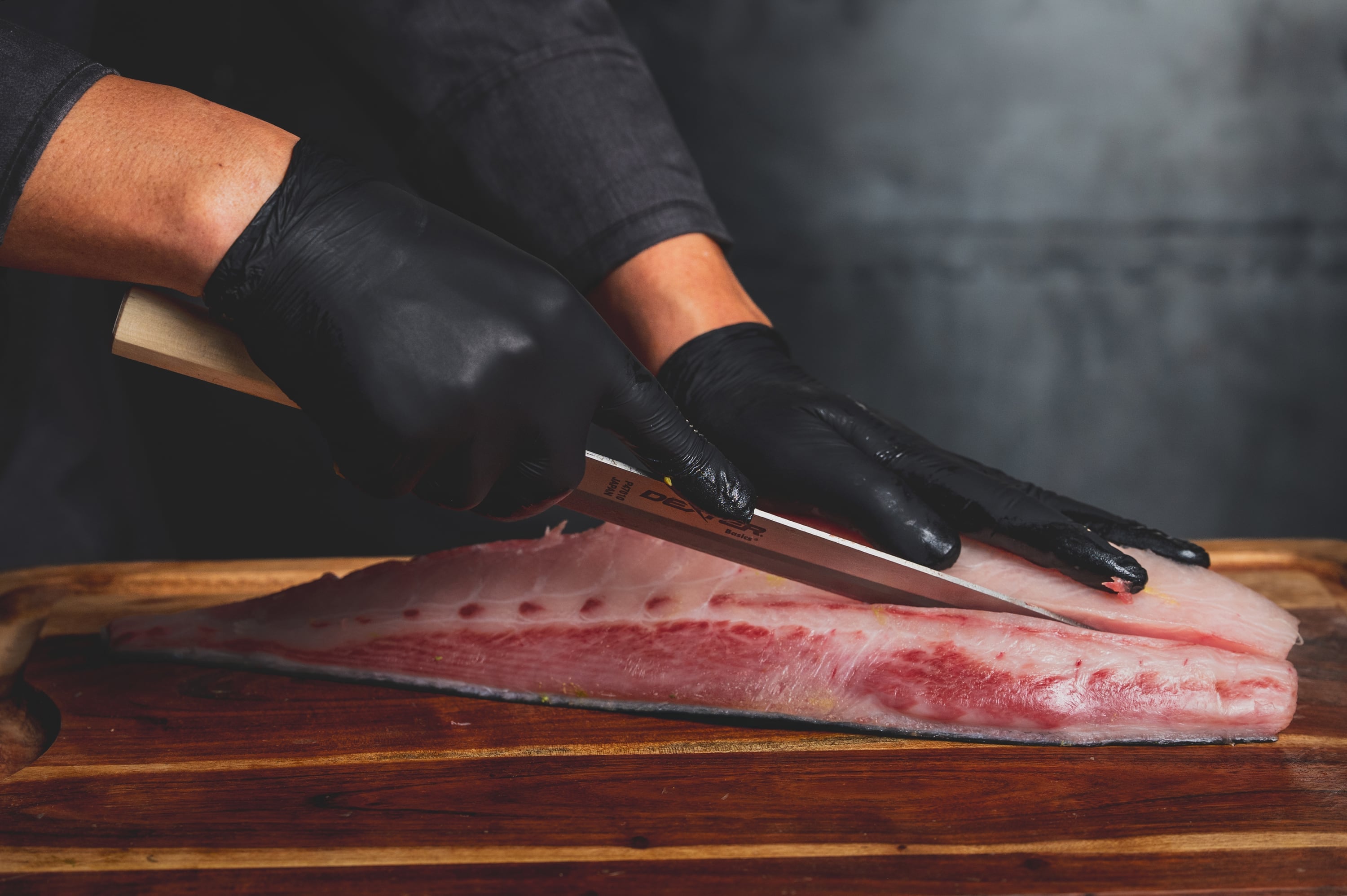 Close-up of sushi preparation with yellowtail fillet