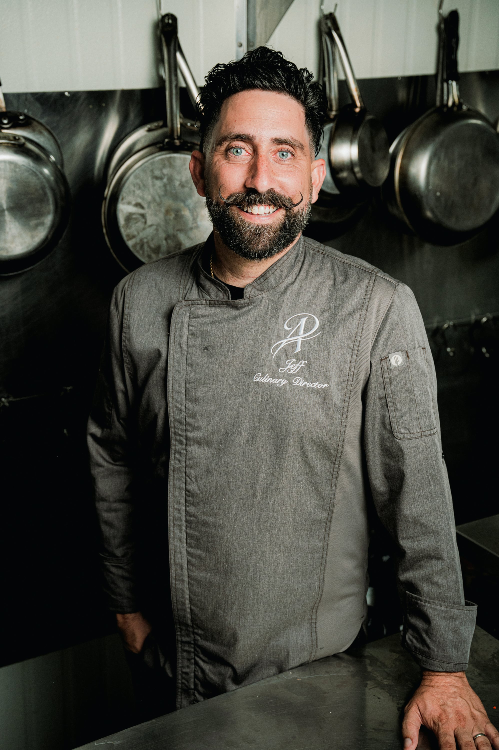 Chef Jeff Ardi leaning at a kitchen counter