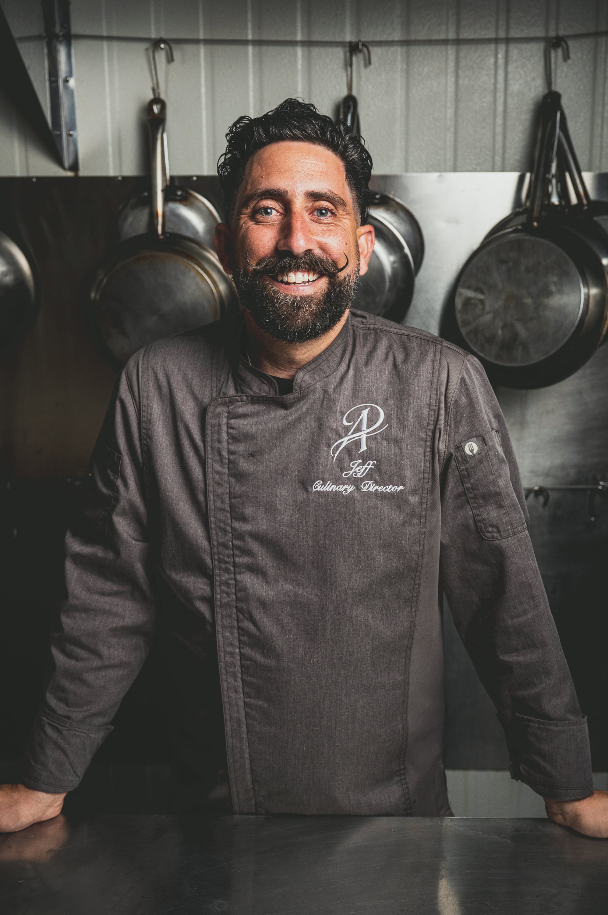 Chef Jeff Ardi, Culinary Director, smiling in the kitchen