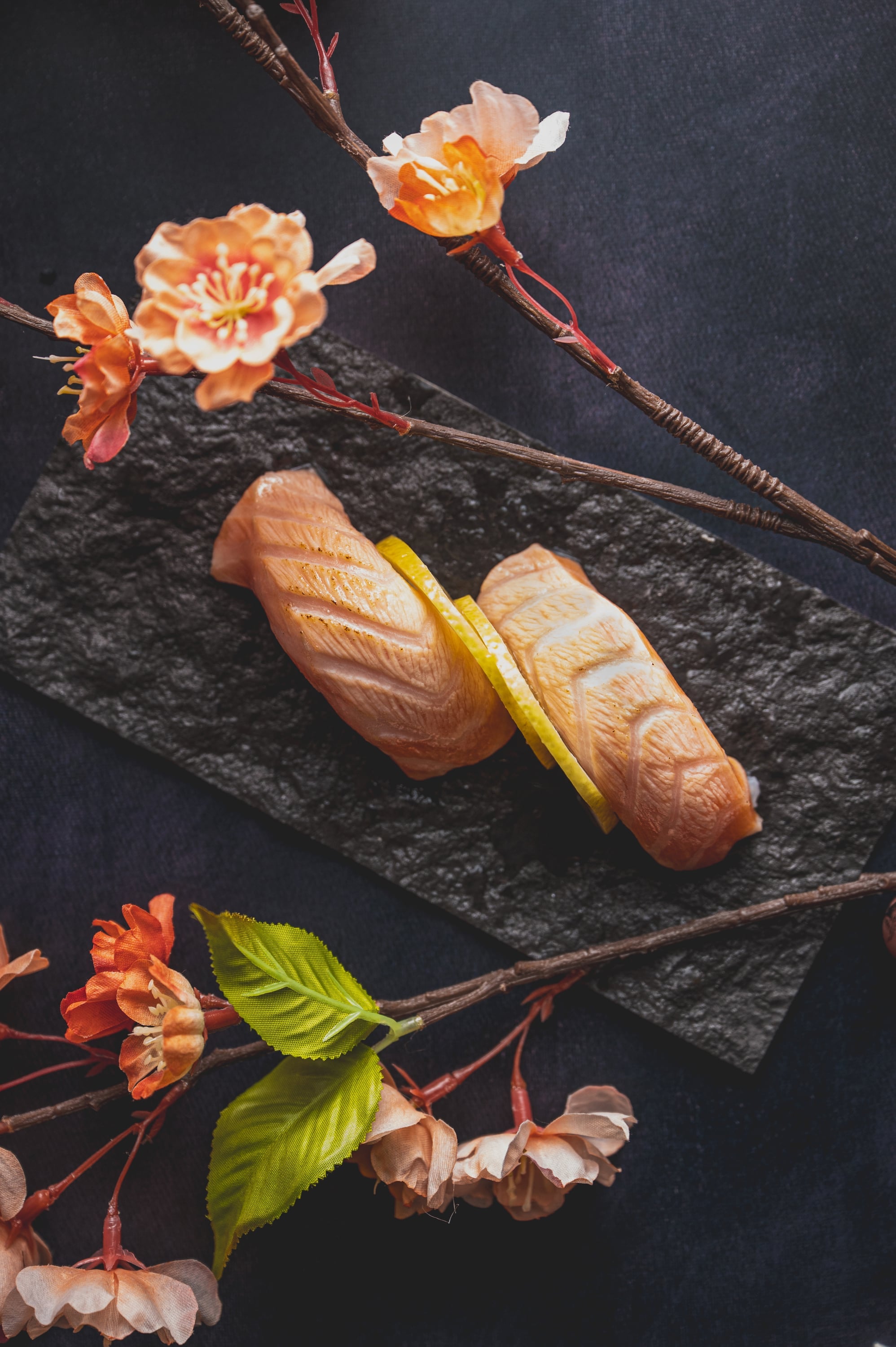 Torched salmon nigiri arranged with cherry blossoms